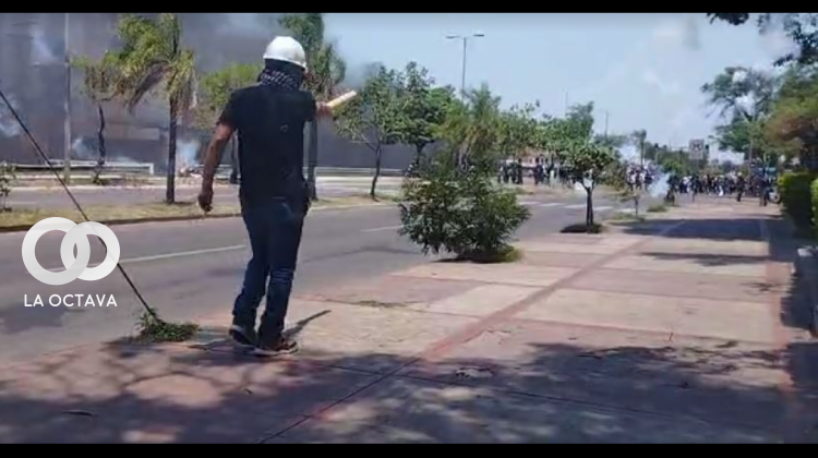 Una persona que es parte del grupo afín al MAS apunta con un petardo a la Policía. Foto. Captura de video.